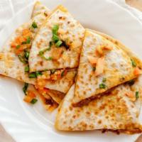 Meat Quesadilla · Flour tortilla filled with melted cheese and our choice of chicken or beef, topped with onio...