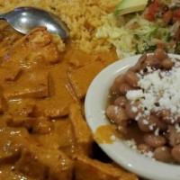 Pollo En Chipotle · Chicken marinated in our special chipotle sauce.  Served with rice, whole beans, avocado, an...