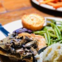 Chicken Marsala · Two moist chicken breasts sautéed with portabella mushrooms. Topped with a rich marsala redu...