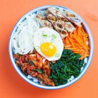 Bibimbap Chicken Bowl · Our bibimbap bowl filled with tender chicken, fermented kimchi, spicy gochujang, a fried egg...