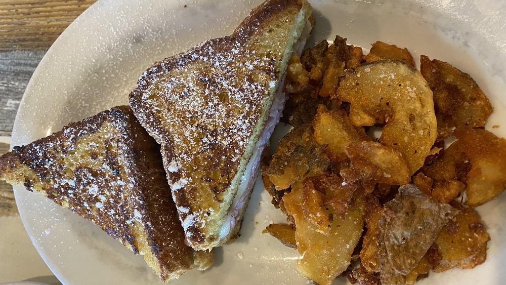 Monte Cristo Sandwich · French toast, with ham, swiss cheese, raspberry jam and maple syrup, with hash browns or breakfast potatoes.
