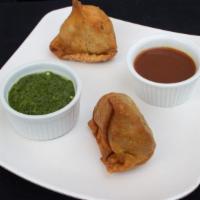 Vegetable Samosa · Wheat flour shell stuffed with spiced potatoes, onions, green peas and spices.