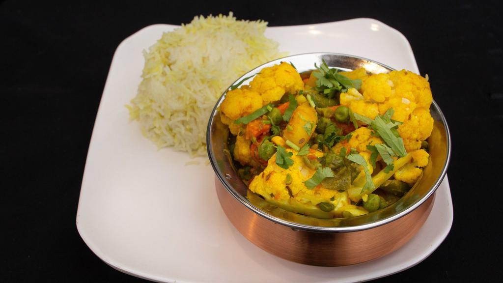 Seasonal Vegetable Curry · South Indian style, fennel, coconut, curry leaves, poppy seeds.