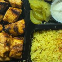 Grilled Chicken Breast Shish Tawook · Gluten-free. Grilled skewers of marinated chicken breasts served with salad, garlic paste an...