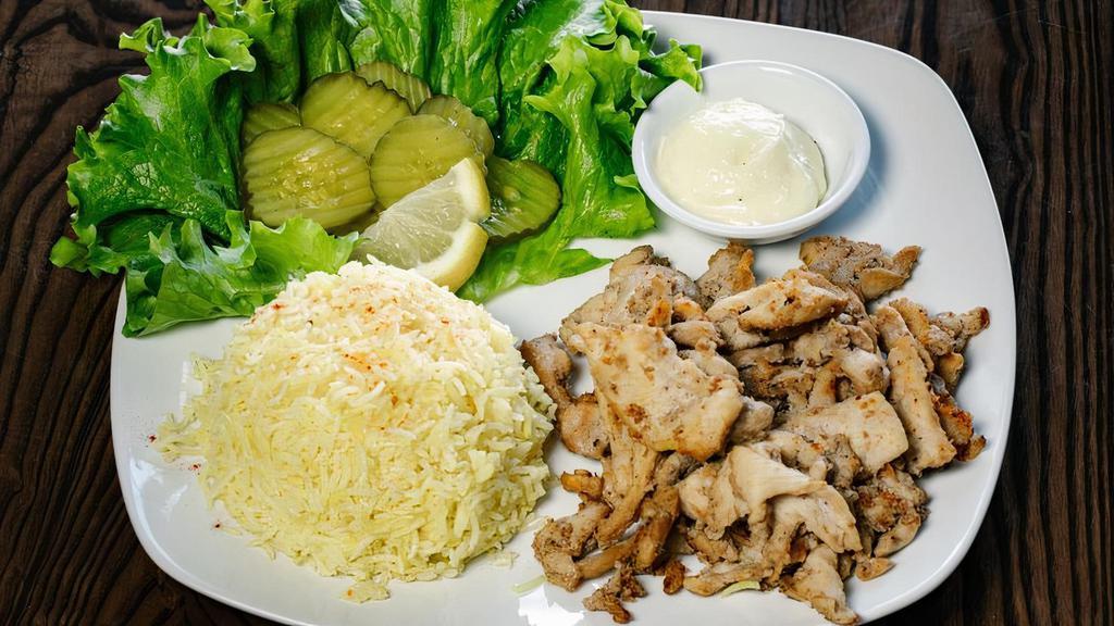 Chicken Shawarma · Gluten-free. Sautéed chicken breast strips served with salad, garlic paste, pickles and basmati rice.