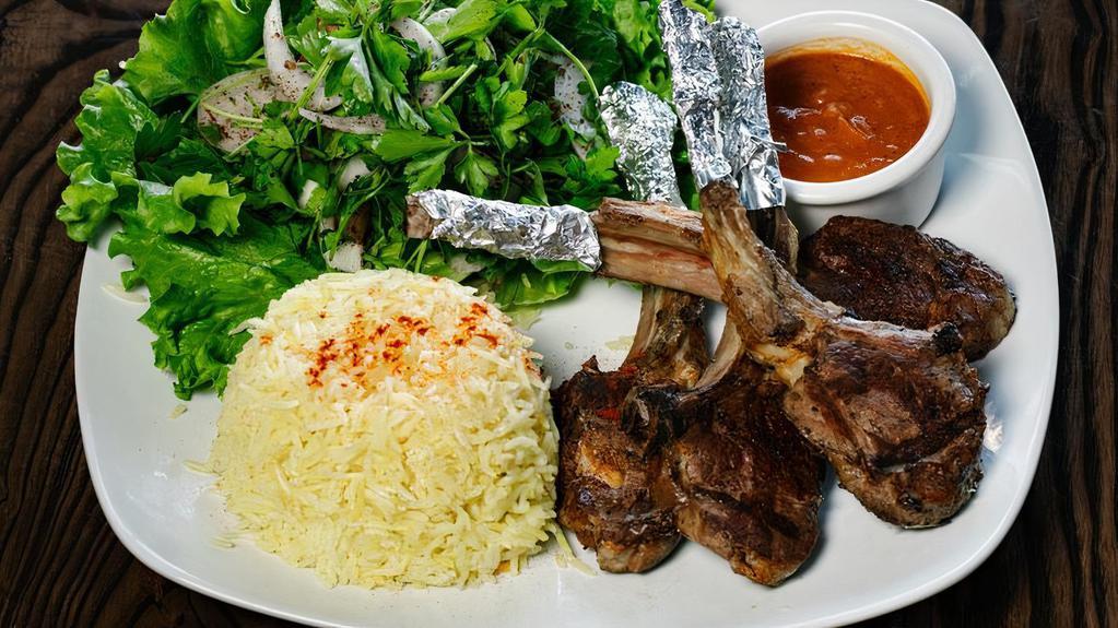 Grilled Lamb Chops · Gluten-free. Grilled lamb ribs served with salad, homemade tomato sauce and basmati rice.