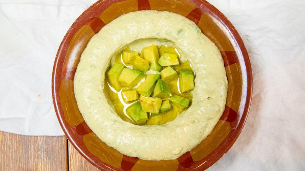 Hummus With Avocado · Gluten-free, Vegan. A blend of garbanzo beans, tahini and fresh lemon juice mixed with fresh avocado served with extra virgin olive oil.