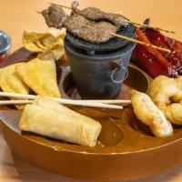 Pu Pu Platter · Includes: 2 ribs, 2 crab puffs, 2 fried shrimp, 2 egg rolls, 2 beef on a stick, 2 wanton.