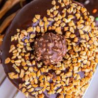 Ferrero Rocher Ring · Raised donut. Chocolate Icing. Peanut Covered. Ferrero Rocher in middle.