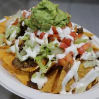 Nachos · Mix of Jack and Cheddar cheese melted with beans, choice of meat, lettuce, tomato, sour crea...