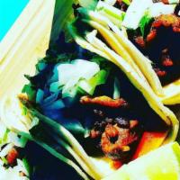 Tacos · Served with double corn tortilla, choice of meat, onion and cilantro.