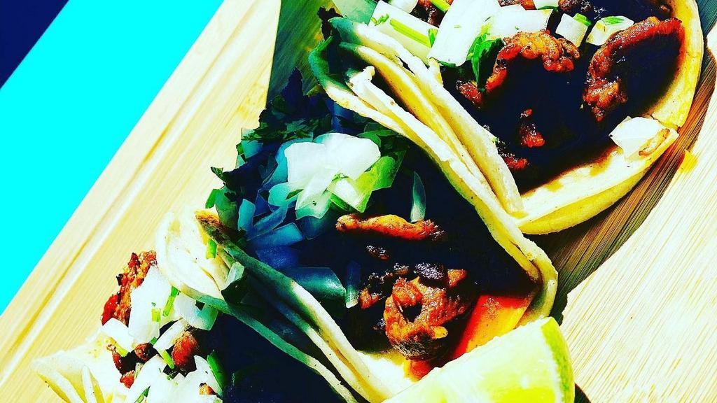 Tacos · Served with double corn tortilla, choice of meat, onion and cilantro.