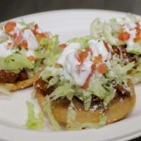 3 Sopes · Deep fried sope shell topped with beans and choice of meat, lettuce, tomato, Mexican cheese ...