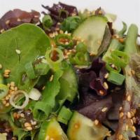 Green Salad With Sesame Dressing · Mixed Green salad with cucumber, scallion, and ginger sesame dressing