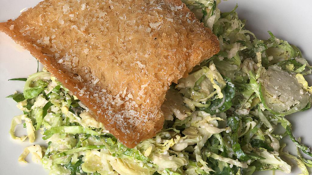 Shaved Brussels Sprouts Caesar · Shaved Brussels Sprouts, Parmesan, House-Made Caesar Dressing & Gnocco Fritto.