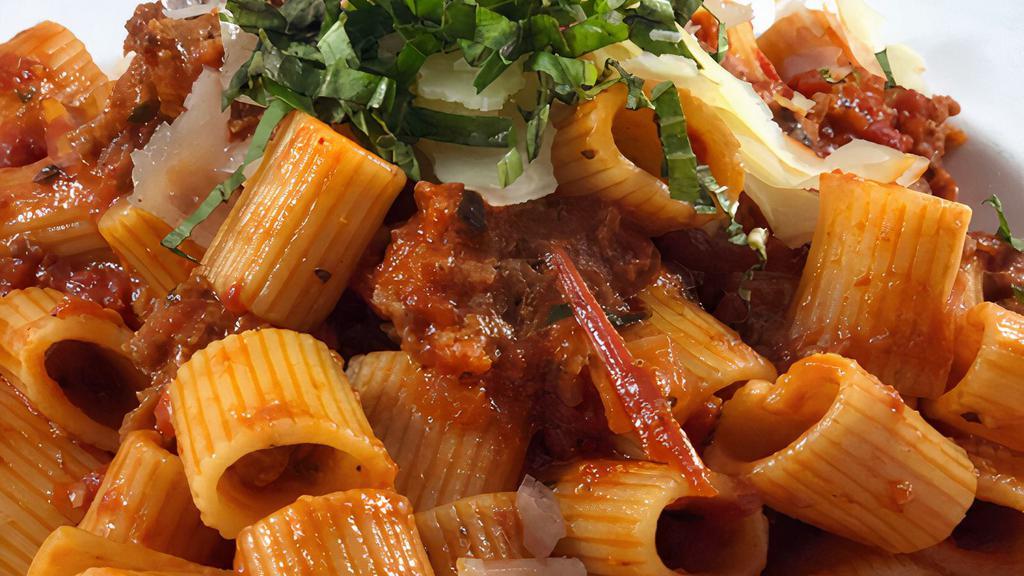 Rigatoni Bolognese · Tube-Shaped Pasta with Veal, Beef, Pork, San Marzano Tomato & Parmesan.