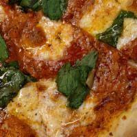Margherita Pizza · San Marzano Tomato, Whole Basil Leaves & Fresh Mozzarella.