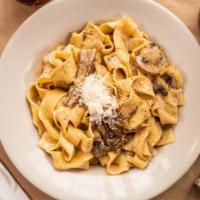 Tagliatelle Ai Funghi · fresh, handmade pasta, porcini, cremini, truffle oil, white wine cream sauce, pecorino.