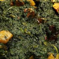Potato Greens · Fresh Cassava Leaf with smoked turkey, smoked fish, chicken, beef, bell peppers and onion wi...