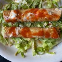 Chicken Taquitos (2) · Shredded chicken in a rolled crispy corn tortilla topped with salsa and sour cream.