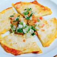 Mulitas · Two grilled corn tortillas filled with cheddar cheese and topped with pico de gallo.