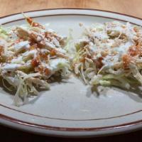 Mini Tostadas (2) · Crisp corn tortillas topped with beans, chicken or beef, cabbage, cotija cheese and sour cre...