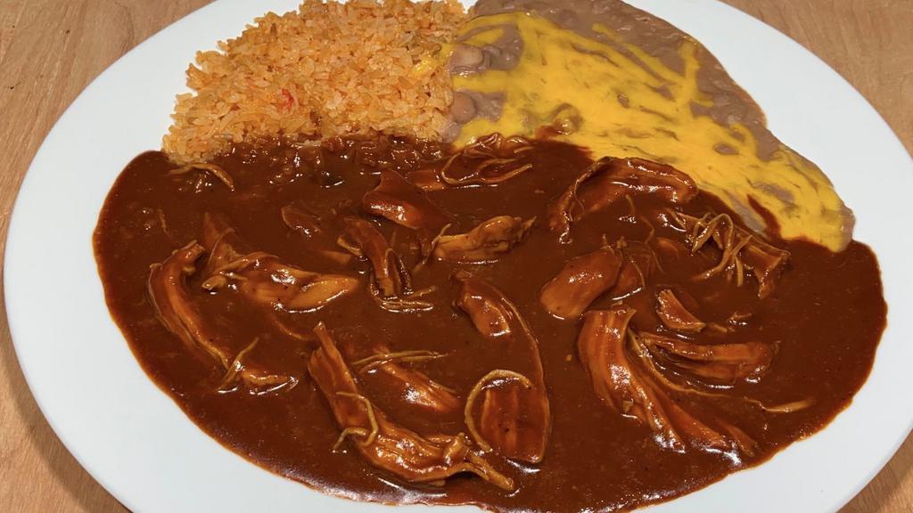 Mole Poblano · Chicken breast pieces in a housemade Puebla-style mole sauce.Served with rice,beans and tortillas