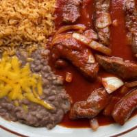 Chile Colorado · Sirloin strips sauteed in a spicy red sauce.Served with rice and beans