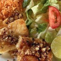 Filet Al Ajo · Garlic grilled true cod served with garlic rice and salad.