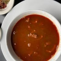 Menudo · Beef tripe in a spicy broth, served with all the fixings!