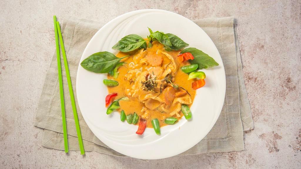 Panang Curry · Panang curry paste, coconut milk, carrot, bell pepper, sweet pea, Thai basil, and topped with kaffir lime leaf.