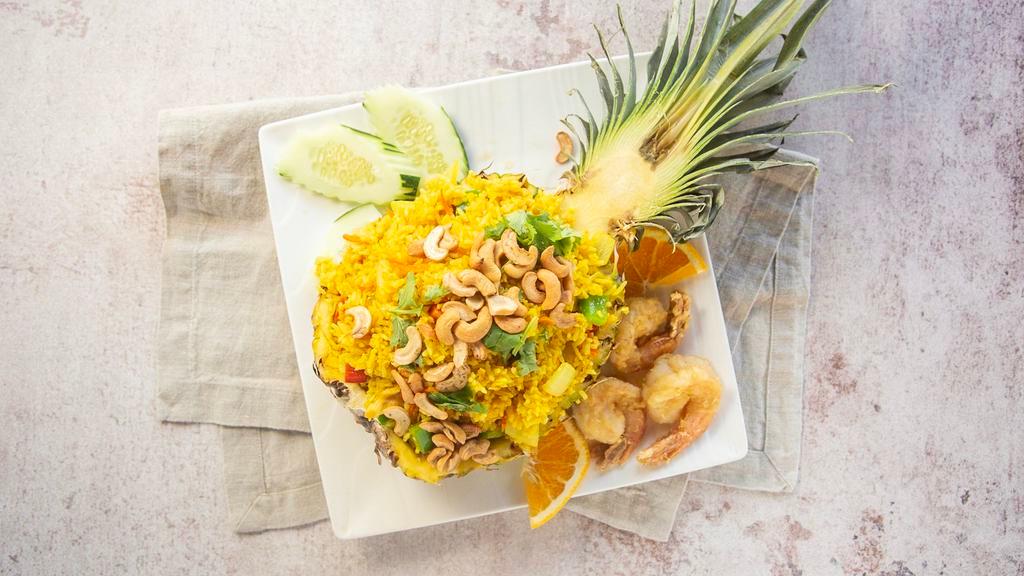Pineapple Fried Rice · Jasmine rice, turmeric, onion, carrot, pineapple, bell pepper, green onion, cilantro, cashews when dining in served in a fresh pineapple shell.