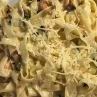 Fettuccini Con Salmon · Fettuccini pasta, smoked salmon, capers and fresh basil in creamy garlic sauce topped with P...