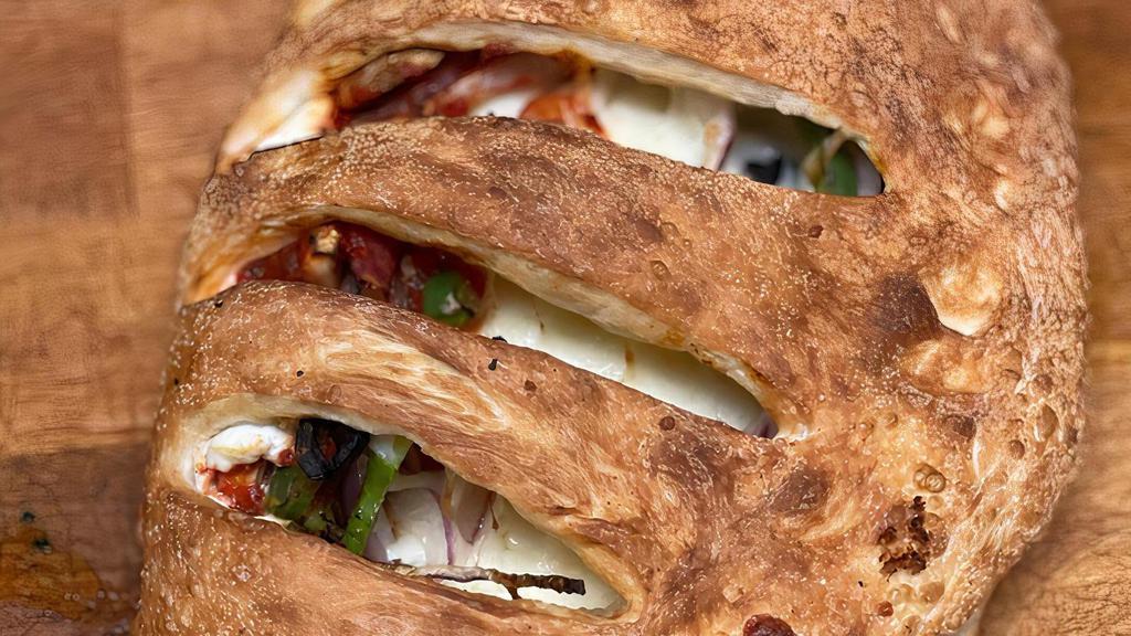 Vegitariano Calzone · Green peppers, black olives, mushrooms and red onions. Vegetarian.