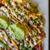 Carne Asada Fries · nacho chips, melted cheese, azada (steak), pico de gallo, sour cream and guacamole and jalap...