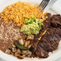 Carne Asada · out side skirt steak served with guacamole,  rice, beans, grill onions  and jalapeno and tor...