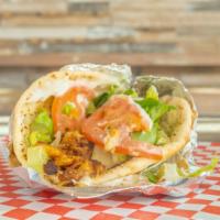 Chicken Shawarma With Garlic Sauce · Rolled in a pita with lettuce, tomatoes, and onions.