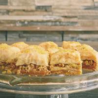 Baklava · Filo dough, simple syrup, and nuts. Baked layered filo dough stuffed with nuts and soaked wi...