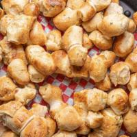 Garlic Knots · Our signature pizza dough smothered in butter and garlic seasoning. These little knots are d...