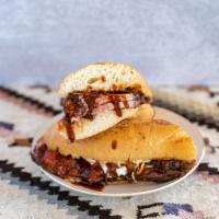 Tri-Tip Sandwich · Slow roasted tri-tip , BBQ sauce, on a french roll