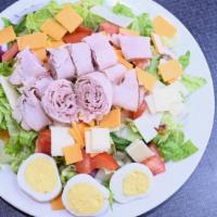 Chef Salad · Lettuce, tomato, cucumber, onion, hard boiled egg, ham, turkey, Swiss and American cheese.