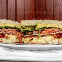 Hell’S Kitchen Sandwich · Egg salad, bacon, Swiss cheese, avocado, and Cajun sauce.   people come from all over for th...
