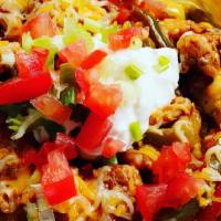 Chicken Fajita Bite · Large buttered potato loaded with a savory chicken fajita mixture w/cheese, topped with sour...