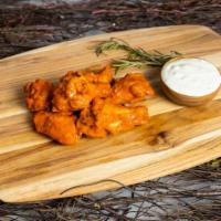 Baffling Buffalo Wings · Our famous wings fried until perfectly golden and crisp. Tossed in buffalo sauce, served wit...