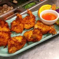 Coconut Prawns · Battered butterfly prawns dressed with coconut flake crispy fried to golden, served with plu...
