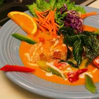 Salmon Curry · Delicious Salmon steak topped with Panang curry sauce, bell, basil, and Crispy Fried Basil.