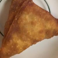 Beef Samosa · Fried pastry with savory beef filling.