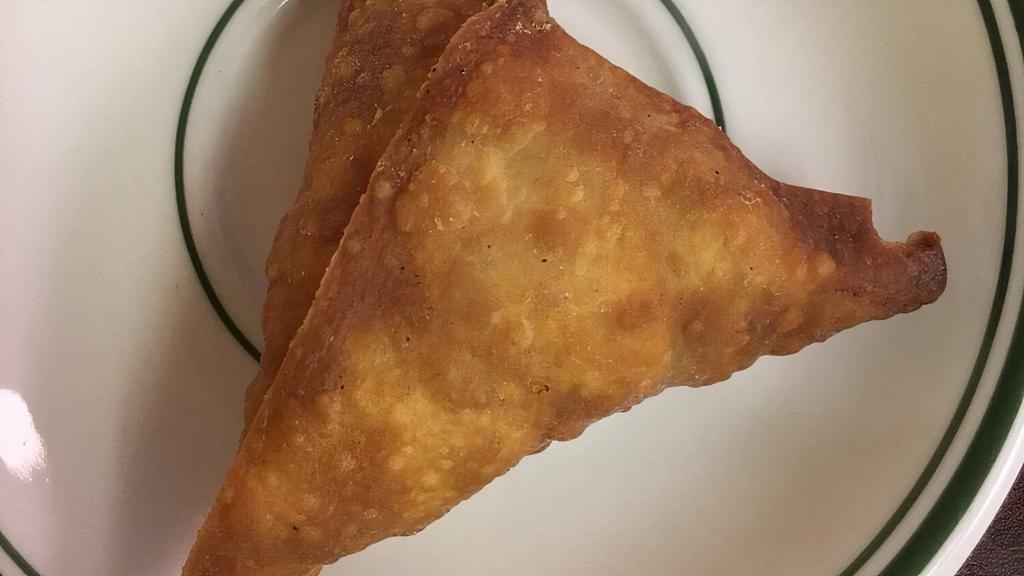 Beef Samosa · Fried pastry with savory beef filling.