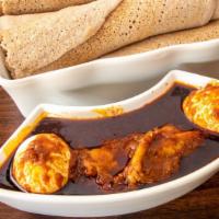 Dero Wot · Spicy. Tender chicken gently simmered in berbere sauce. Served with a boiled egg.