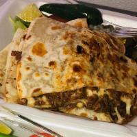 Quesadillas · Flour tortilla filled with melted cheese, meat with side of lechuga, tomato, onion, cilantro...